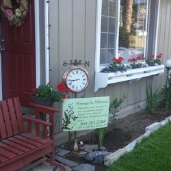 Massage By Mikenzie - Signage in front of office with red front door and red garage door