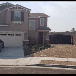 Concrete poured on left side to extend driveway. Rock gravel and planter area installed. Concrete poured on left side to extend driveway. Rock gravel and planter area installed.