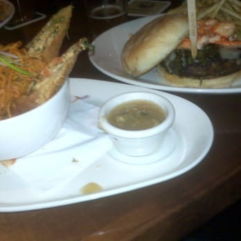 Yard House - Moo Shu Egg Rolls (Left) and Surf and Turf Burger with Garlic Herb Fries (right) - Bars Near Me - Houston, Texas Yard House - Moo Shu Egg Rolls (Left) and Surf and Turf Burger with Garlic Herb Fries (right) - Bars Near Me - Houston, Texas