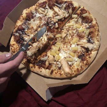 Domino's Pizza - a person cutting into a pizza - Pizza Near Me - Pullman, Washington Domino's Pizza - a person cutting into a pizza - Pizza Near Me - Pullman, Washington