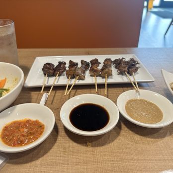 Gourmet Sate House - From left to right saté (chicken hearts, lamb, pork belly, baby octopus with fried rice) - Indonesian Near Me - Pensacola, Florida Gourmet Sate House - From left to right saté (chicken hearts, lamb, pork belly, baby octopus with fried rice) - Indonesian Near Me - Pensacola, Florida