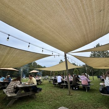 Doc Waters Cidery - Outdoor covered seating and dry benches after a rainy night/morning - Cideries Near Me - Germantown, Maryland