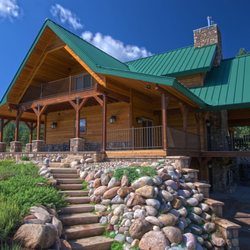 Colorado Dream Homes - Custom home with real cedar wood siding and standing seam metal roof.