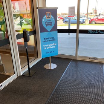 ALDI - the entrance to a store with a sign in front of it - Grocery Near Me - Lafayette, Louisiana