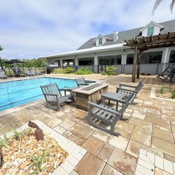 Sun Outdoors Orange Beach - Rocking chairs and fire pit tables by the pool.