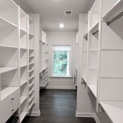 Victory Closets - Galley walk-in closet design with extended height panels, soft-close drawers, glide-out hamper and shoe shelves