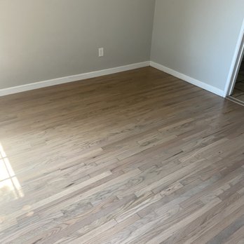 IR Hardwood Flooring - a hardwood floor in an empty room - Flooring Near Me