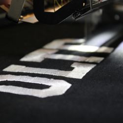 Oltre Apparel - Oltre stitched in athletic font using the Melco machine.