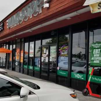 Wingstop - a white car parked in front of a fast food restaurant - Chicken Wings Near Me - San Pedro, California Wingstop - a white car parked in front of a fast food restaurant - Chicken Wings Near Me - San Pedro, California