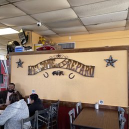 people sitting at tables in a restaurant