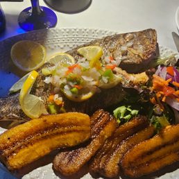 Whole baked snapper with salad and plantains