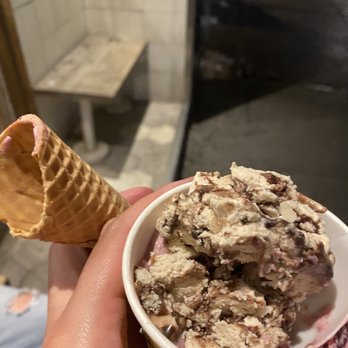Van Leeuwen - a hand holding a cone of ice cream - Coffee & Tea Near Me - Brooklyn, New York
