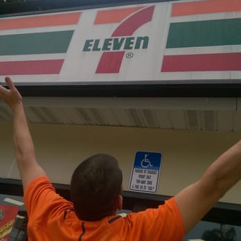 7-Eleven - a man in an orange shirt reaching for a sign - Convenience Stores Near Me - Pembroke Pines, Florida 7-Eleven - a man in an orange shirt reaching for a sign - Convenience Stores Near Me - Pembroke Pines, Florida