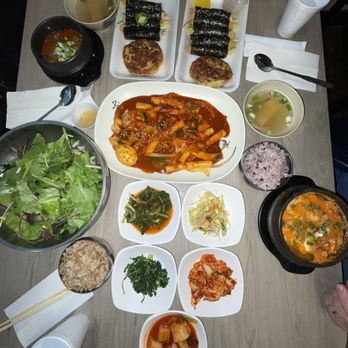 Dduk Bae Gi Hot Stone & Korean Kitchen - a table full of food - Korean Near Me - Dallas, Texas Dduk Bae Gi Hot Stone & Korean Kitchen - a table full of food - Korean Near Me - Dallas, Texas