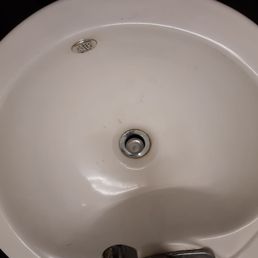 Dirty sink with hair and other miscellaneous substances Dirty sink with hair and other miscellaneous substances