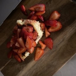 One slice of cheese cake with strawberry tangerine compote.