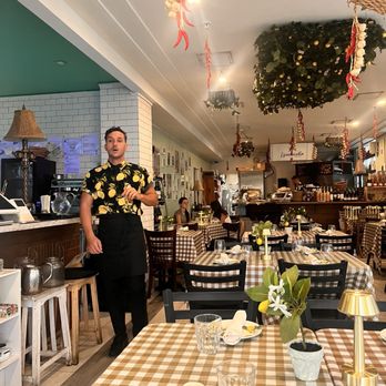 Limoncello - a man standing in a restaurant - Italian Near Me - Miami Beach, Florida Limoncello - a man standing in a restaurant - Italian Near Me - Miami Beach, Florida