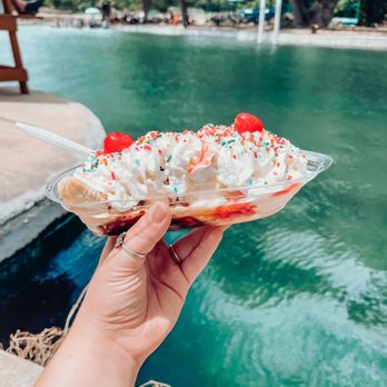 The Shack - a hand holding a banana split with whipped cream and sprinkles - Shaved Ice Near Me - New Braunfels, Texas The Shack - a hand holding a banana split with whipped cream and sprinkles - Shaved Ice Near Me - New Braunfels, Texas