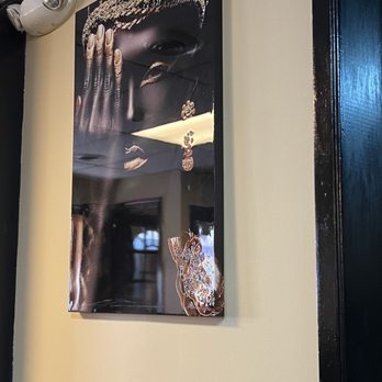 Caribbean Dynasty - a picture of a woman's face on the wall - Caribbean Near Me - Baltimore, Maryland