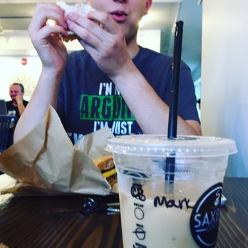 Saxbys - a man sitting at a table eating a sandwich - Coffee & Tea Near Me - Philadelphia, Pennsylvania Saxbys - a man sitting at a table eating a sandwich - Coffee & Tea Near Me - Philadelphia, Pennsylvania