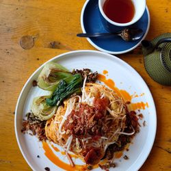 Rude Boy Deli & Eatery - Kim chi, bean sprouts, chili scrambled egg, atop brioche with bok choy.