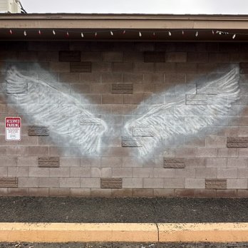 Big River Pizza & Grill - an angel wing painted on the side of a building - Pizza Near Me - Arlington, Oregon