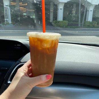 Dunkin' -  a hand holding a cup of iced coffee - Donuts Near Me - Daytona Beach, Florida