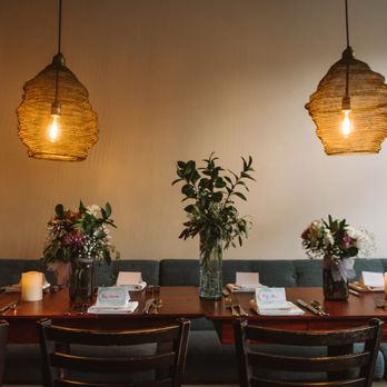 Urban Hearth - a dining room with a table and chairs - New American Near Me - Cambridge, Massachusetts