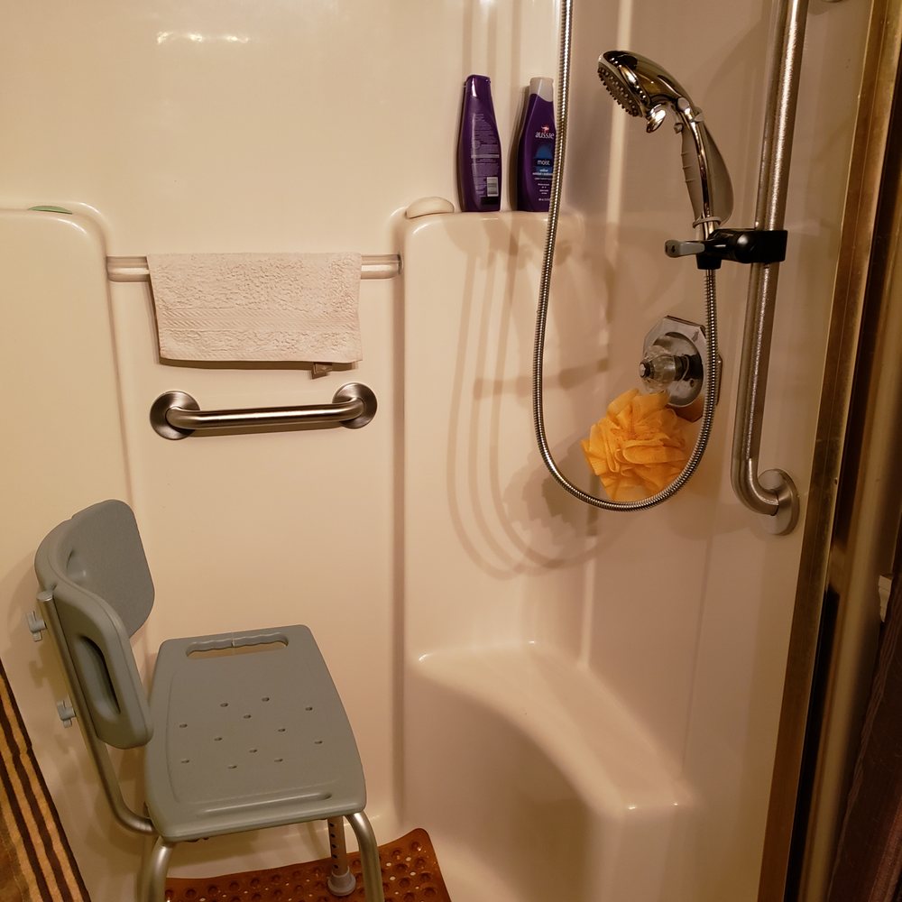 Slip Busters - a shower with a chair in it - General Contractors Near Me Slip Busters - a shower with a chair in it - General Contractors Near Me