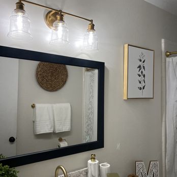 Calming Home By Venus - Upgraded Vanity Light (Gold)
The vanity has a white cultured marble countertop with a gold faucet. - Home Organization Near Me