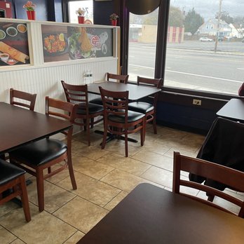 Chennai Express - Chennai Express's tiny dining area - 4 tables, 4 chairs apiece - Indian Near Me - Cranston, Rhode Island