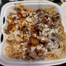 Mr Roboto Tokyo Grill - Steak  & chicken  hibachi with noodles  and rice  mix. Some yum yum sauce on top!