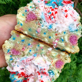 Krammed Kookies - a hand holding a piece of cake - Desserts Near Me Krammed Kookies - a hand holding a piece of cake - Desserts Near Me