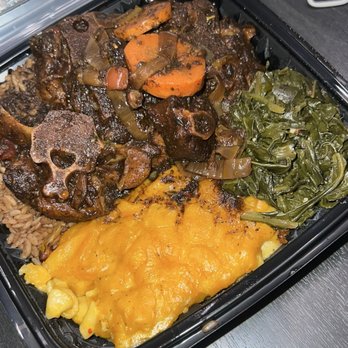 Ruby's Jamaican Kitchen - Oxtail dinner plate with macaroni and cheese, greens and rice - Caribbean Near Me - Alexandria, Virginia Ruby's Jamaican Kitchen - Oxtail dinner plate with macaroni and cheese, greens and rice - Caribbean Near Me - Alexandria, Virginia