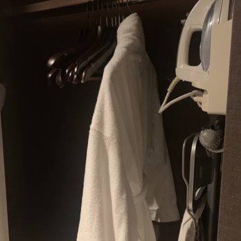 帝京酒店 - Closet with ironing board, robe, hangers, cloth sandals. - Hotels Near Me - Hong Kong, HK