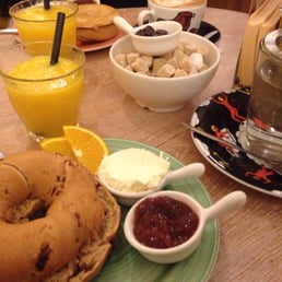 Breakfast morning bagels cinnamon and raisin with tea coffe and juice Breakfast morning bagels cinnamon and raisin with tea coffe and juice