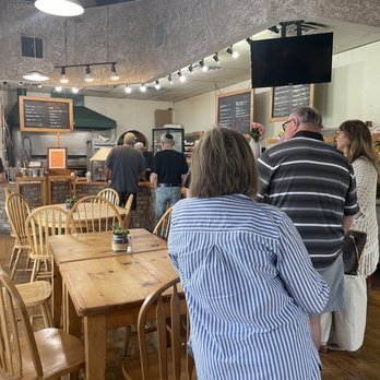 Benny's Bagels - a group of people standing around a table - Bagels Near Me - Dallas, Texas