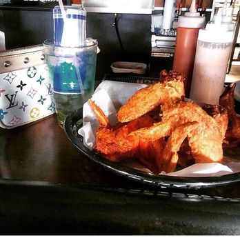 Gunny's Lounge - Gunnys wings with their signature sauce depicted next to the hot sauce and my favorite cocktail of theirs called the trash can. Yummy! - Bars Near Me - New Kensington, Pennsylvania Gunny's Lounge - Gunnys wings with their signature sauce depicted next to the hot sauce and my favorite cocktail of theirs called the trash can. Yummy! - Bars Near Me - New Kensington, Pennsylvania