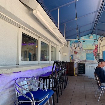 Taso's Greek Taverna - a man sitting at a table - Greek Near Me - Delray Beach, Florida