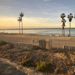 Pacific Surfliner - View from a train passes coastal parks, pullouts, and public areas, some with surfing.