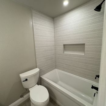 J&K Tile and Remodel - Bathroom remodel in Camarillo, CA. New bathtub with large wall tile and recessed niche. Porcelain wood-look floor tile. - General Contractors Near Me J&K Tile and Remodel - Bathroom remodel in Camarillo, CA. New bathtub with large wall tile and recessed niche. Porcelain wood-look floor tile. - General Contractors Near Me