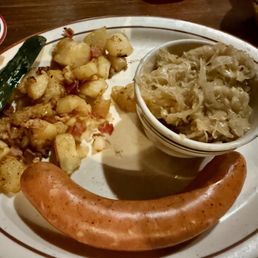 Käiserkrainer with sauerkraut, German mustard and German fried potatoes.