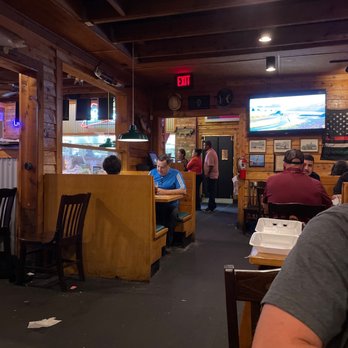 Texas Roadhouse - a man sitting at a table in a restaurant - Steakhouses Near Me - Denton, Texas