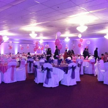 Bloomers Flowers - Banquet Hall setup: overlays, chair sashes, balloon centers at tables - Florists Near Me - Hayward, California