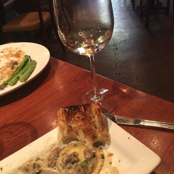 Wild River Grille - Wild mushroom ravioli with garlic bread & Pinot Gregio. - New American Near Me - Reno, Nevada