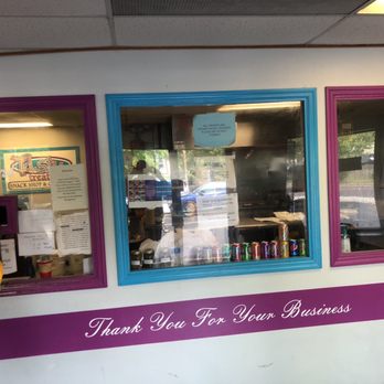 Tasty Treats - a woman standing in front of a window - Burgers Near Me - Saint Louis, Missouri