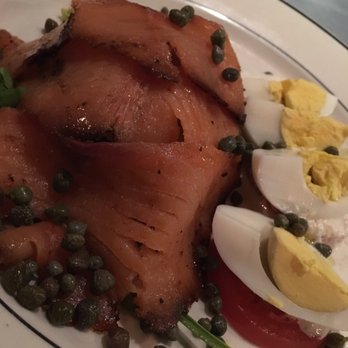 Johnny's - "Pastrami style" smoked salmon and eggs with capers, tomato, and horseradish sauce on a pile of lettuce - Seafood Near Me - Baltimore, Maryland