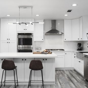 Macabi Builders - a kitchen with white cabinets and stainless steel appliances - General Contractors Near Me - Sherman Oaks, California