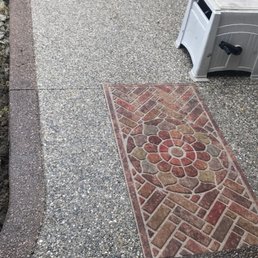 a brick walkway with a flower design a brick walkway with a flower design