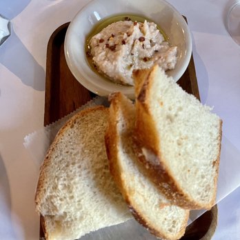 L'Osteria Ristorante - a plate of bread and a bowl of dip - Italian Near Me - Cranston, Rhode Island L'Osteria Ristorante - a plate of bread and a bowl of dip - Italian Near Me - Cranston, Rhode Island